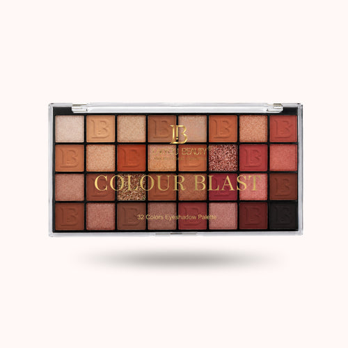 A 32-color eyeshadow palette by Estée Lauder, featuring a grid of warm-toned shades including beige, brown, orange, pink, red, and gold shimmer, with the brand name 'Estée Lauder' and product name 'COLOUR BLAST' printed on the front.
