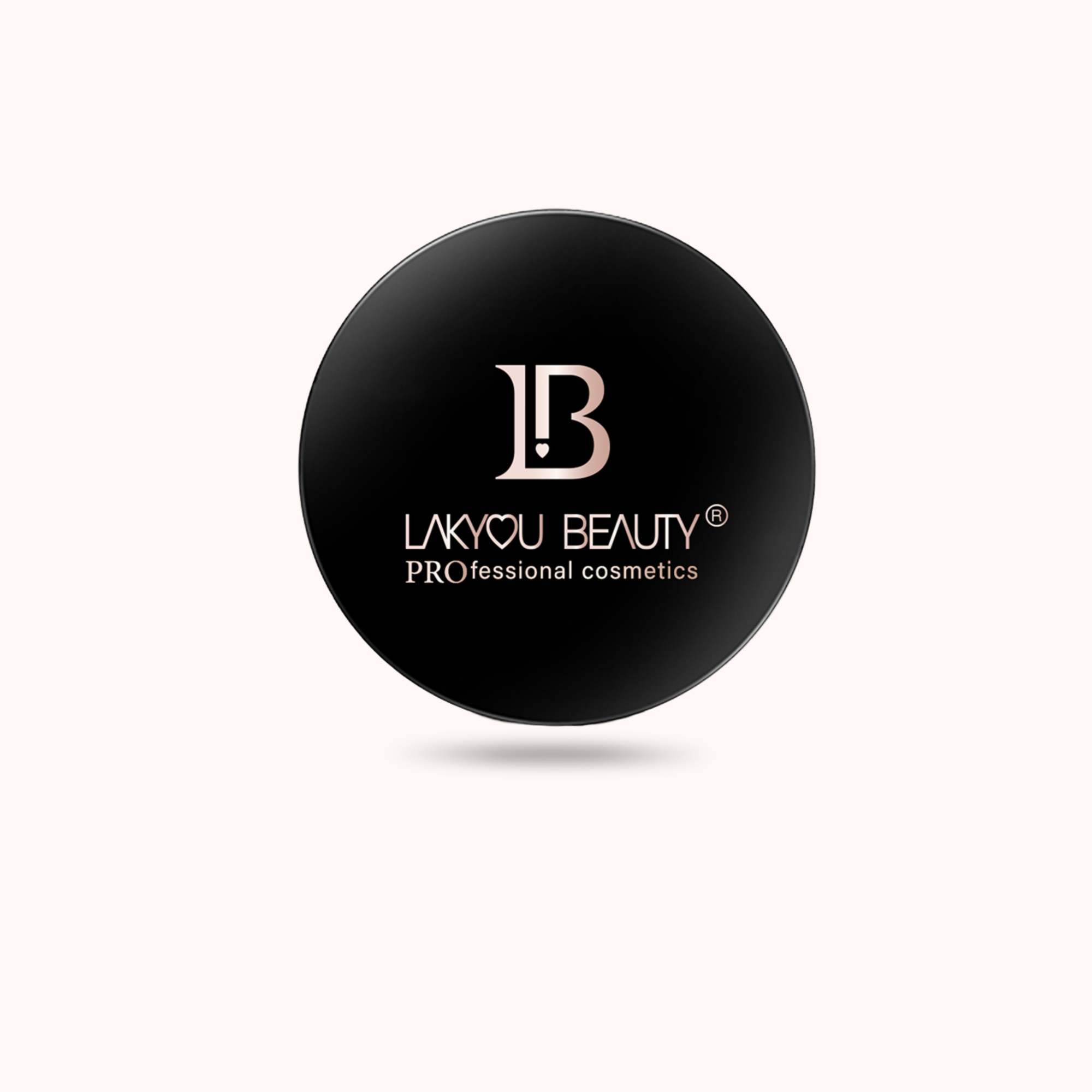 A round black cosmetic compact lid with a metallic rose gold logo and the text 'LAKYOU BEAUTY Professional cosmetics' on a light cream background.