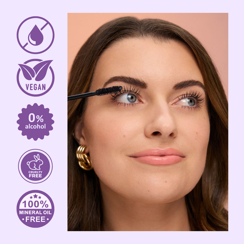 Woman applying mascara with a purple background featuring vegan, alcohol-free, cruelty-free, and mineral oil-free icons.